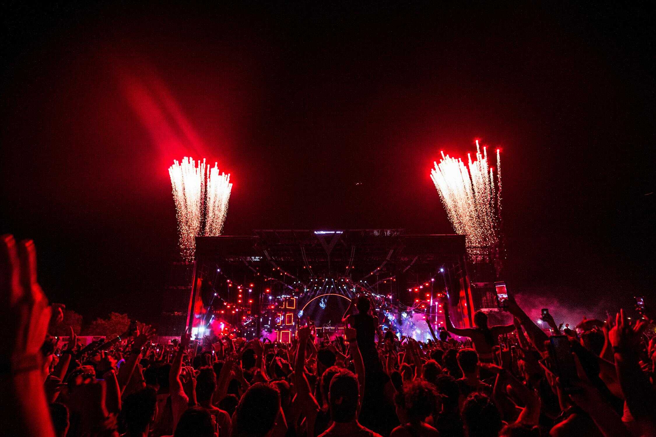 Opening ceremony stage with fireworks and colorful lights representing viral cultural moments